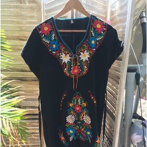 Black cotton embroidered dress, black ties at waist, bright embroidery